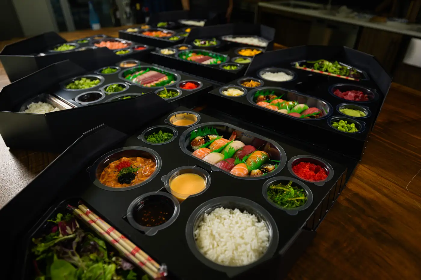 Multiple sushi boats being prepared in the kitchen