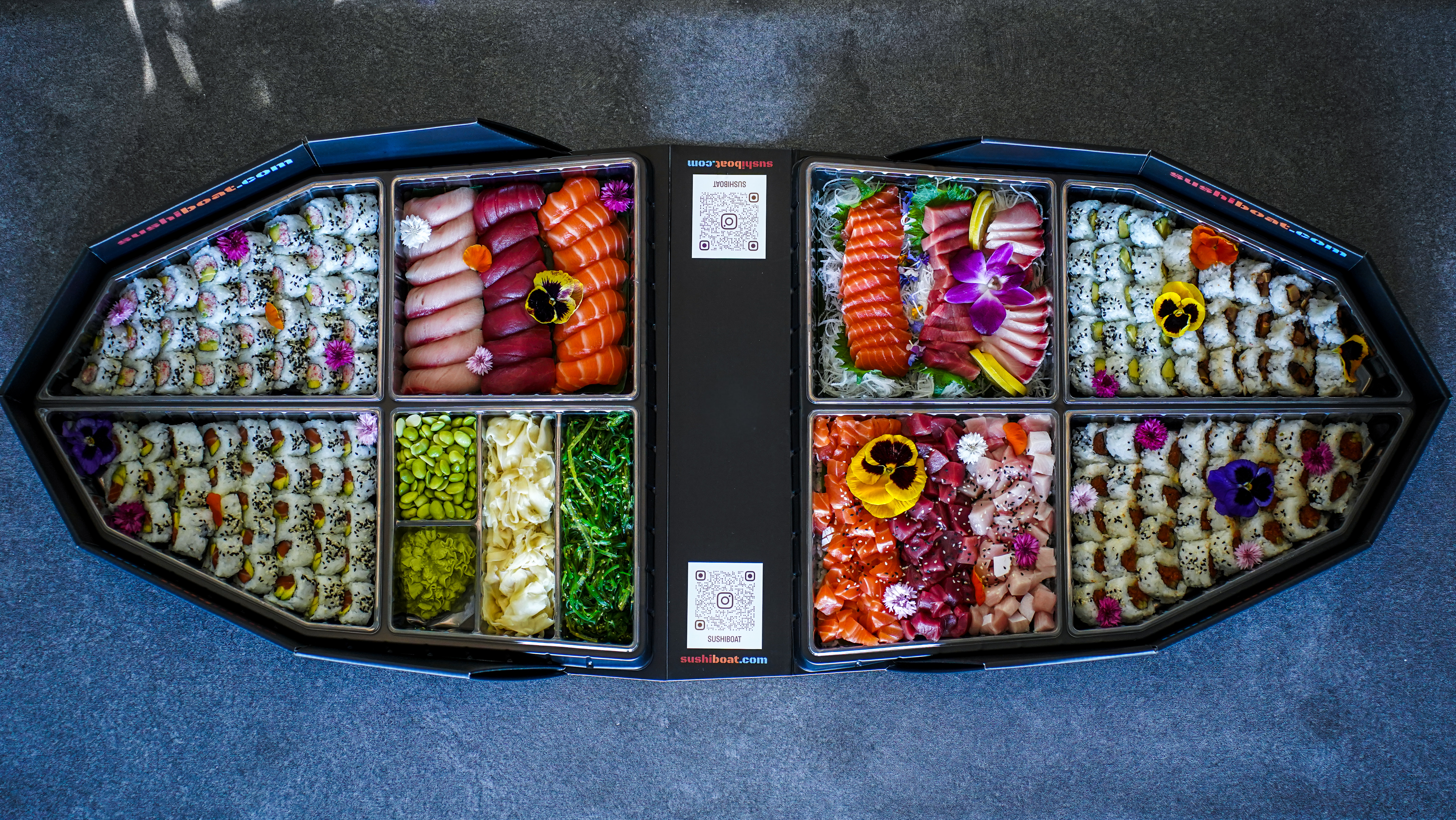 Sushi Boat premium sampler party boat opened from above showing rolls, nigiri, sashimi, edamame and all the fixings