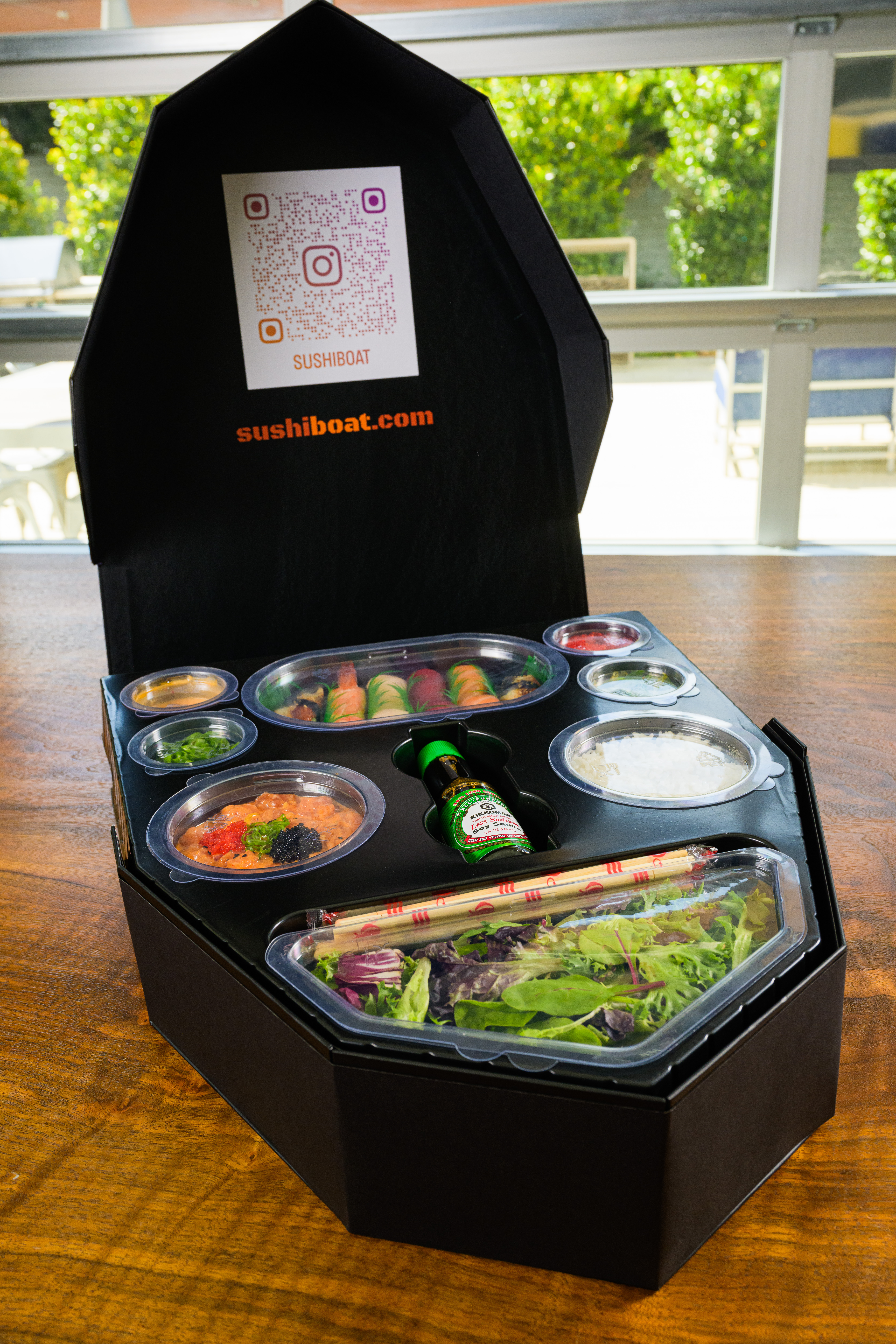 Sushi Boat branded box opened showing all compartments with sushiboat.com branding